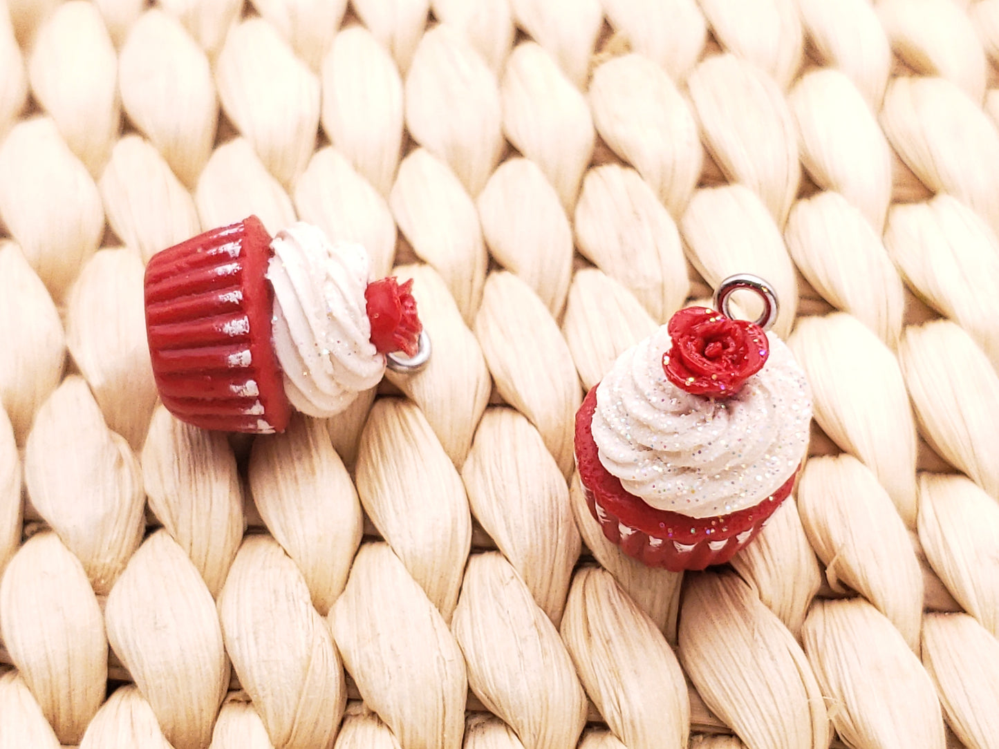 two red and white cupcakes sitting on top of a table
