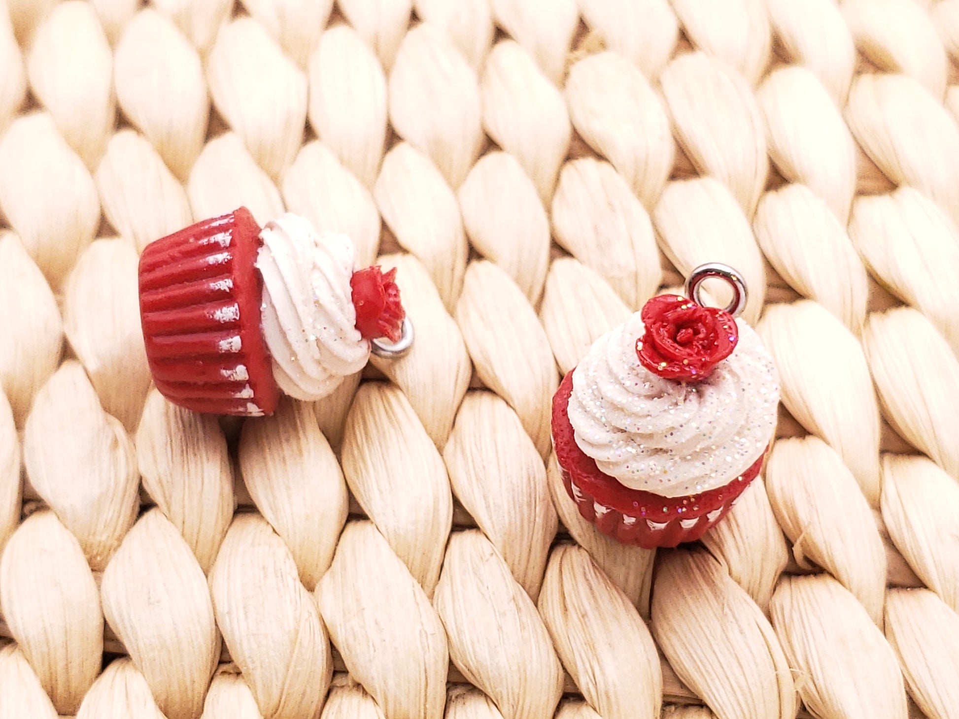two red and white cupcakes sitting on top of a table